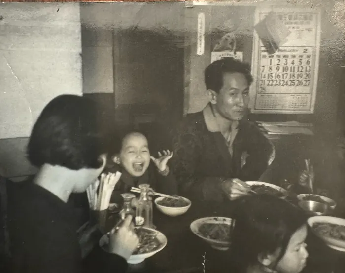 The family at the table in Seoul, before the move to Houston